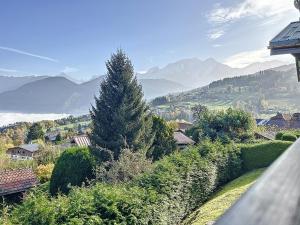 a view of the mountains from a house with a tree at Studio mezzanine chaleureux au centre de Combloux avec parking - FR-1-560-123 in Combloux +9 photos