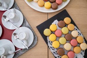 a table with plates of pastries and cups of coffee at LOGIS Hôtel de Bourgogne - Mâcon in Mâcon +86 photos