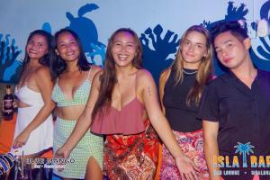 a group of girls posing for a picture at a party at MUBA HOSTEL in Moalboal