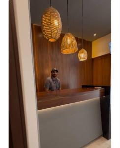a man standing in front of a bar with lights at Penthouse cerca de la playa in Tulum