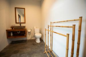 a bathroom with a toilet and a sink and a mirror at Skylake Villa in Kubupenlokan +47 photos