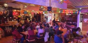 a group of people sitting at tables in a restaurant at Hotel Colonial Campestre in UniÃ³n JuÃ¡rez