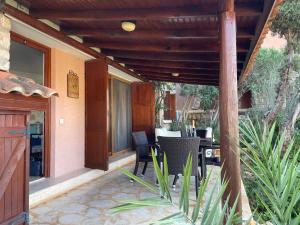 a patio with a table and chairs on a house at Villa Olive Garden, Kalkan ClubPatara in Kalkan