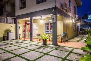 a patio of a house at night at Plumeria 4BR Garden House by uBook in Butterworth