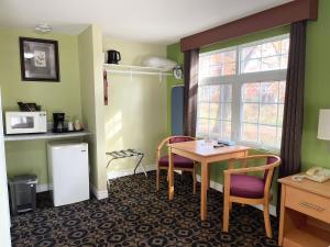 a room with a table and chairs and a window at North Bay Inn in North Bay