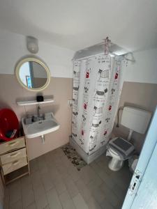 a bathroom with a toilet and a shower curtain at Hotel Glaros Lipsi in Leipsoi