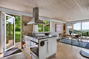 a kitchen with a stove and a dining room at Nice Home In Knebel With 3 Bedrooms in Knebel