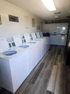 a large room with white counters and white appliances at Black Canyon Campground Modern Sleeping Pods Tiny Homes in Black Canyon City