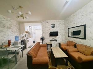 a living room with a couch and a table at Amaia Steps Altaraza by GEMcondotel in Tunkong Manga