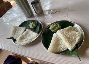 two plates of food sitting on a table at Happy Cottages in Velas