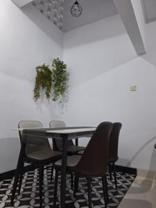 a dining room with a table and chairs at White House Royal Villa B1 in Balong