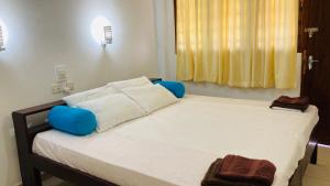 Una cama con sillas azules en una habitación. en Siri Tourist Holiday Home, en Hikkaduwa