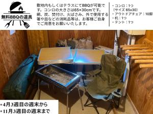 a desk with a chair and a table with a bag at Midori House - walking distance to Rusutsu Resort in Rusutsu