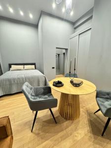 a bedroom with a bed and a table and chairs at EVIS LTD apartments 4 in Rēzekne