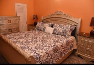a bedroom with a large bed and a dresser at Irie Smart Villa 2 in Falmouth +58 photos