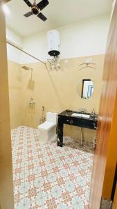a bathroom with a toilet and a sink and a mirror at Umaid Niwas Homestay in Jaipur +61 photos