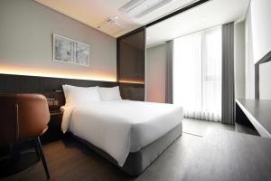 Krevet ili kreveti u jedinici u okviru objekta Homes Stay Myeongdong