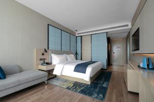 Letto o letti in una camera di Eharm Hotel Jingzhou Olympic Sports Center
