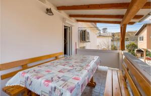 a bed on the balcony of a house at Awesome Apartment In Rab With Wifi in Rab