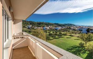a balcony with a view of a green field at Awesome Apartment In Rab With Wifi in Rab +25 photos