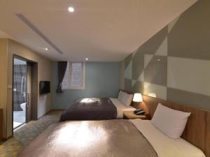 Postel nebo postele na pokoji v ubytování Ximen Hotel B + 33 fotografií