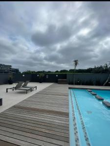 a deck with a swimming pool on a building at Umhlanga Modern Nest Studio in Durban
