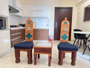 a kitchen with two wooden surfboards and two stools at 1 Bed Room Suite Elysium Tower-Opposite Centaurus Mall Islamabad in Islamabad
