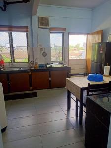 a kitchen with a counter and a table in it at Sarah homestay in Port Dickson