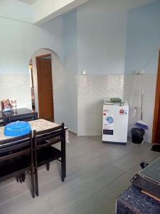 a room with a refrigerator and a table in it at Sarah homestay in Port Dickson