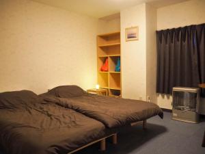 Postel nebo postele na pokoji v ubytování Guest House Moshiripa