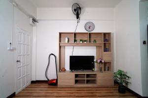 a living room with a television and a vacuum at Villa Zuzu Holiday Phuket in Kata Beach