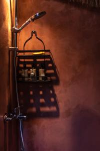 a shadow of a towel rack on a wall at Alpaca Lodge in Tanah Lot