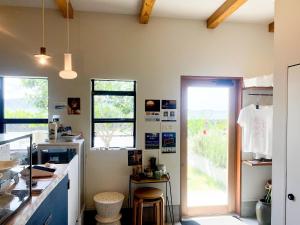 a kitchen with a counter and a door to a yard at HOLLY CAMP CASA in Akagina
