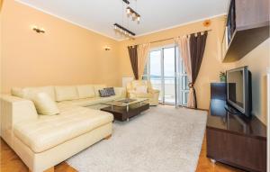 a living room with a couch and a television at Three-Bedroom Holiday Home In Sibenik in Šibenik +23 photos