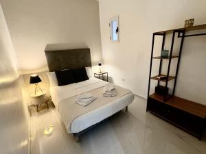 a bedroom with a bed with two towels on it at Maison Santa Lucia in Naples