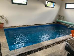 a swimming pool in a house with blue water at l'an dormi vacances in La Plaine des Cafres