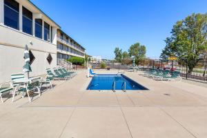 a swimming pool with chairs and a building at Comfort Inn Somerset in Somerset