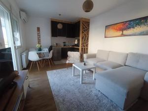 a living room with a couch and a table at Apartmani Krunet in Kruševac