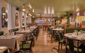 a restaurant with tables and chairs in a room at Hôtel Reisen in The Unbound Collection by Hyatt in Stockholm