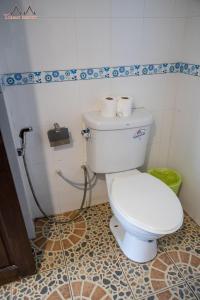 a bathroom with a white toilet in a room at Tommy Resort in Haad Rin