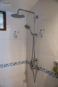 a shower with a shower head in a bathroom at Tommy Resort in Haad Rin