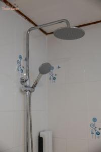 a shower with a shower head in a bathroom at Tommy Resort in Haad Rin