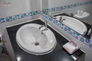 a bathroom with a white sink and a mirror at Tommy Resort in Haad Rin