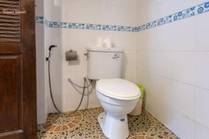 a bathroom with a toilet with a hose at Tommy Resort in Haad Rin