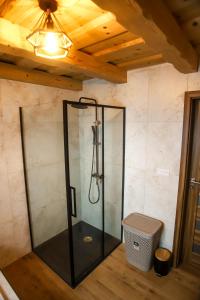 a glass shower in a room with a ceiling at North Resorts Lucas in Novoť