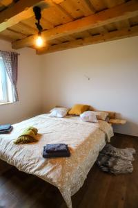 a bedroom with a large bed in a room with wooden ceilings at North Resorts Lucas in Novoť