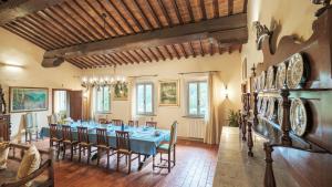 a dining room with a blue table and chairs at IL CERRETO 11, Emma Villas in Pontedera