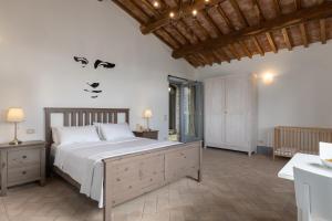 a bedroom with a bed with a face painted on the wall at VILLA DEI ROSMARINI 8, Emma Villas in Orvieto +30 photos