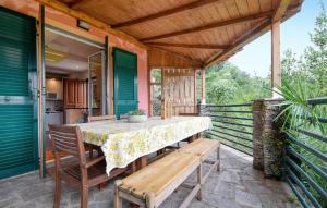 a table and benches on a porch with a kitchen at Awesome Apartment In Casarza Ligure in Casarza Ligure +11 photos