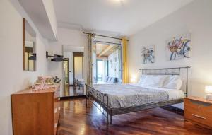 a bedroom with a bed and a dresser and a mirror at Awesome Apartment In Casarza Ligure in Casarza Ligure
